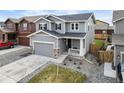 Two-story home with grey siding, stone accents, and well-maintained landscaping at 27674 E 7Th Dr, Aurora, CO 80018