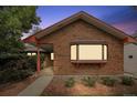 Attractive brick home showcasing a front bay window, fresh landscaping, and covered entry at 4720 S Grant St, Englewood, CO 80113