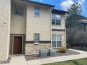 Attractive townhome exterior with a mix of stone and stucco, well-maintained landscaping, and a welcoming front door at 7489 S Quail Cir # 814, Littleton, CO 80127