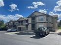 Modern condo building featuring stone accents, private balconies, and visitor parking spaces at 7489 S Quail Cir # 814, Littleton, CO 80127