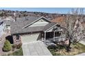 A stunning aerial shot of a single-Gathering home with a well-manicured lawn, driveway, and mature trees, offering a serene setting at 8199 W 67Th Ave, Arvada, CO 80004
