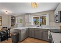 Well-lit kitchen with ample counter space, modern appliances, and a convenient breakfast bar for casual dining at 9598 Lou Dr, Northglenn, CO 80260