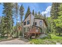 Beautiful mountain home with a charming deck and swing, nestled among tall trees in a serene setting at 5739 Highway 9, Breckenridge, CO 80424