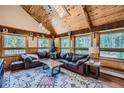 Spacious living room featuring wood ceilings, large windows, comfortable seating, and stylish decor at 5739 Highway 9, Breckenridge, CO 80424