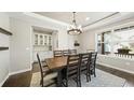 Bright dining room with built in bar, large wood table and upholstered chairs at 8867 S Zante St, Aurora, CO 80016