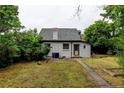 Backyard featuring a well-maintained lawn and mature trees at 1707 W 39Th Ave, Denver, CO 80211