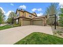 Large three-car garage with a basketball hoop, perfect for storage and recreational activities at 15258 W 75Th Pl, Arvada, CO 80007