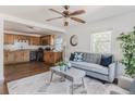 Inviting living room seamlessly connected to the kitchen with hardwood floors and ample natural light at 2260 Lilly Dr, Thornton, CO 80229