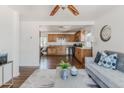 An open-concept living room flows into the kitchen, creating a welcoming space for relaxation and entertainment at 2260 Lilly Dr, Thornton, CO 80229