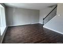 Spacious living room features hardwood floors, a large window and staircase at 1285 Colorado Blvd # 3, Denver, CO 80206