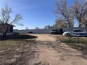 Long driveway leading up to property with parked vehicles at 7486 Patrick St, Fort Lupton, CO 80621