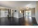 Open living area showcasing hardwood floors, neutral paint and direct access to the backyard at 10560 W 102Nd Pl, Broomfield, CO 80021