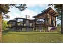 Stunning modern home showcasing balconies, expansive windows, and lush green surroundings at 7935 Dante Dr, Littleton, CO 80125