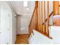 Bright entryway features hardwood floors, a staircase with wooden railings, and a high ceiling at 12388 E Caspian Dr, Aurora, CO 80014