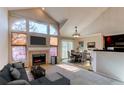 Inviting living room with a fireplace, large windows, and an adjacent dining area with stylish decor at 12388 E Caspian Dr, Aurora, CO 80014