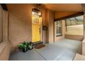 Inviting front porch features a yellow door and charming details at 30 Fox St, Denver, CO 80223