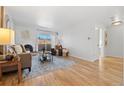 Spacious living room with hardwood floors, fireplace, and plenty of natural light at 252 N Pennsylvania St # 305, Denver, CO 80203
