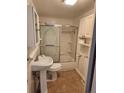 This bathroom features a shower and tub combination with a sliding door at 8 S Kendall St, Lakewood, CO 80226