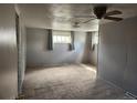 An empty bedroom, features carpet, windows, and ceiling fan at 8 S Kendall St, Lakewood, CO 80226