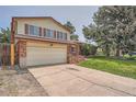 Charming two-story home with a large two-car garage and concrete driveway at 1824 S Granby St, Aurora, CO 80012
