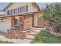 Close-up of the home's entrance, showcasing a brick facade and decorative front door at 1824 S Granby St, Aurora, CO 80012