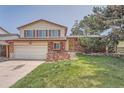 Lovely home featuring brick accents, neutral siding, and a spacious front yard at 1824 S Granby St, Aurora, CO 80012