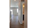 Hallway leading into an open living space, and a partial view of a bathroom to the side at 393 Grey Rock St, Brighton, CO 80601