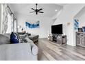 Bright living room features contemporary decor, comfortable seating, and stylish ceiling fan at 5131 Andes St, Denver, CO 80249