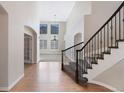 Bright entryway featuring hardwood floors, staircase, and views to the formal living area at 11010 Grayledge Cir, Highlands Ranch, CO 80130