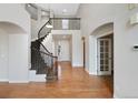 Open entryway features hardwood floors and a gracefully curved staircase at 11010 Grayledge Cir, Highlands Ranch, CO 80130