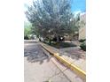 Serene condo street view surrounded by mature trees and beautiful landscaping at 14852 E Kentucky Dr # 934, Aurora, CO 80012