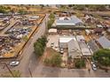 A neighborhood and yard of a home from above and surrounded by adjacent commercial buildings, scrap yard and train tracks at 5182 Thompson Ct, Denver, CO 80216