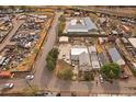 Overhead shot of neighborhood and home, which is surrounded by auto salvage yard, commercial buildings and train tracks at 5182 Thompson Ct, Denver, CO 80216
