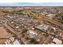 Aerial view looking toward horizon and buildings. The home in surrounded by train tracks and auto salvage yards at 5182 Thompson Ct, Denver, CO 80216