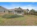 Inviting single-Gathering home featuring a charming front porch and well-manicured lawn at 3342 Quail Ridge Cir, Parker, CO 80138