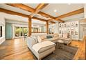 Open-concept living room features wood beams, hardwood floors, and a large sectional sofa at 700 Cheyenne St, Golden, CO 80401