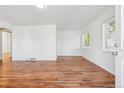 Bright living room featuring gleaming hardwood floors and ample natural light at 4624 S Lincoln St, Englewood, CO 80113