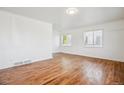 Spacious living room featuring hardwood floors and multiple windows for natural light at 4624 S Lincoln St, Englewood, CO 80113