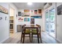 Bright dining area featuring a wooden table, seating for four, and access to the backyard at 2557 S Dover St # 85, Lakewood, CO 80227