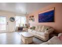 Comfortable living room with a cozy sofa, accent chair, and ample natural light at 2557 S Dover St # 85, Lakewood, CO 80227