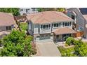 Aerial view of a charming two-story home with a brick facade, and an attached two-car garage at 15353 E 98Th Pl, Commerce City, CO 80022