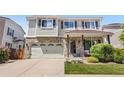 Charming two-story home featuring a brick facade, well-maintained lawn, and attached two-car garage at 15353 E 98Th Pl, Commerce City, CO 80022