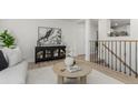 Bright living room featuring modern decor, light wood floors, and neutral tones, creating a welcoming and airy atmosphere at 6699 S Pennsylvania St, Centennial, CO 80121