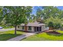 Charming single-story home with a well-maintained lawn and mature trees in a quiet neighborhood at 1420 S Leyden St, Denver, CO 80224