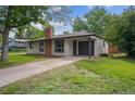 Single story home with brick chimney and attached garage at 1420 S Leyden St, Denver, CO 80224