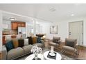 Bright living room with open layout to dining area and view of kitchen at 1420 S Leyden St, Denver, CO 80224