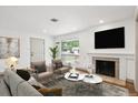 Cozy living room featuring a fireplace, hardwood floors, and natural light at 1420 S Leyden St, Denver, CO 80224