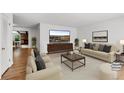 A modern living room with neutral-toned furniture and decor, creating a comfortable space at 420 Dudley St, Lakewood, CO 80226