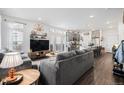 Open-concept living room featuring modern decor and seamless flow to the kitchen at 20000 E 40Th Ave # 4, Denver, CO 80249