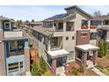 Rear exterior view of a modern home with solar panels on the roof, multiple balconies, and neat landscaping at 4535 W 50Th Ave, Denver, CO 80212